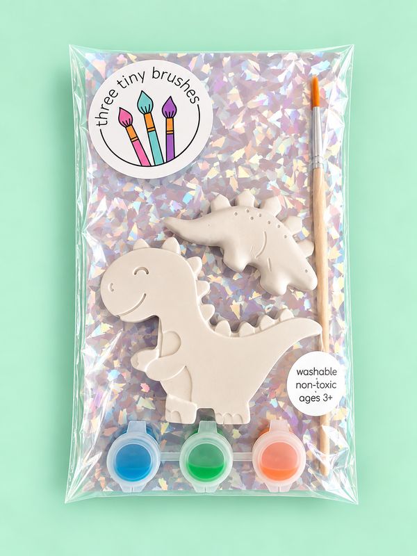 Dino Pals party pack: a paintable T-rex and a small spiky dino with three paint pots and a brush