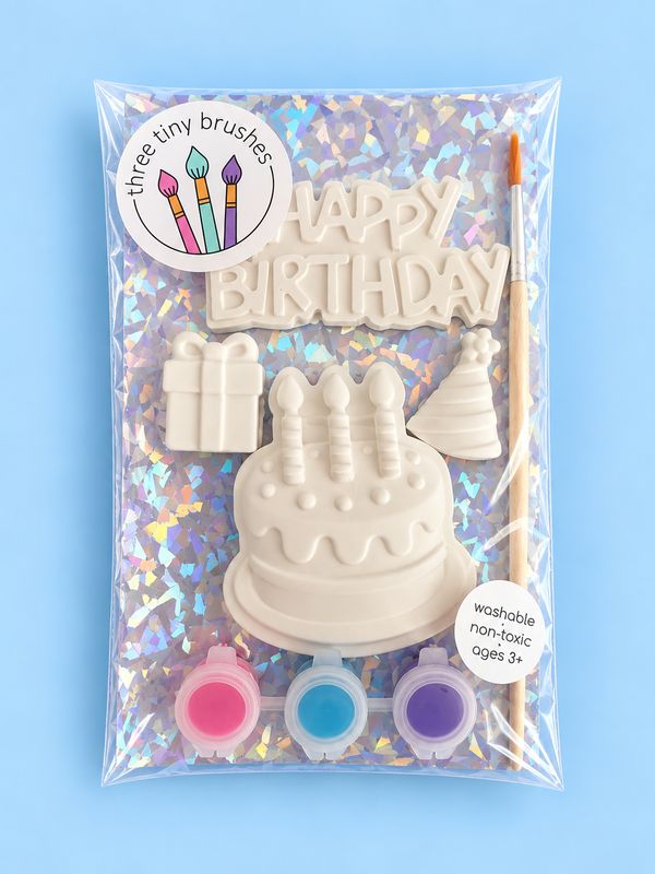 Happy Birthday party pack: a paintable cake, present, party hat and “Happy Birthday” plaque with three paint pots and a brush